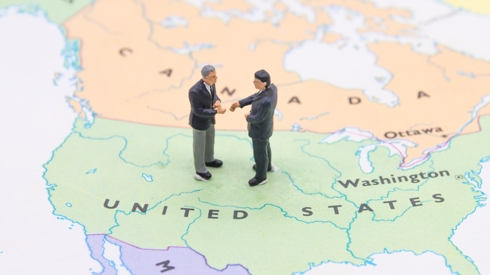 two people standing at the border between Canada and the United States Map